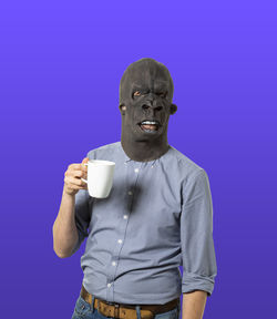 Portrait of man holding coffee cup against blue background