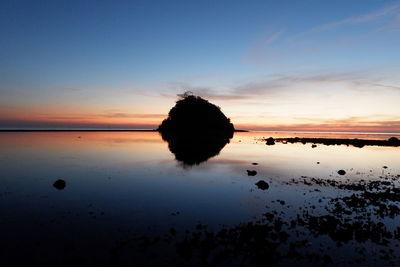 Scenic view of sea against sky at sunset