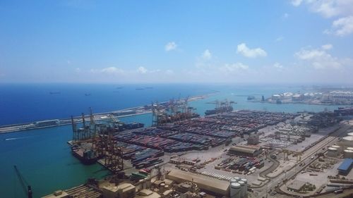 High angle view of cityscape by sea against sky