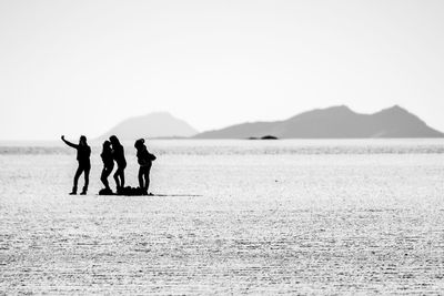 Silhouette of tourists on beach