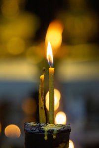 Close-up of lit candles in temple