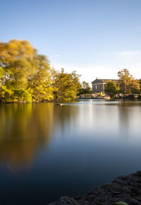 Scenic view of lake by building against clear sky