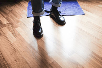 Low section of people standing on hardwood floor