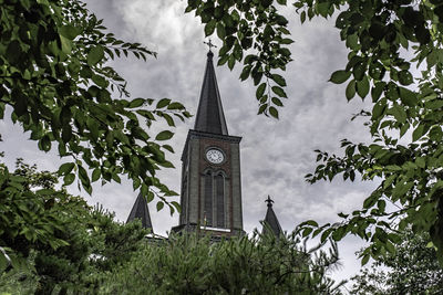 Low angle view of clock tower against sky