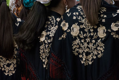 Rear view of woman wearing traditional clothing indoors