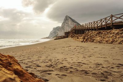 Built structure on beach against sky