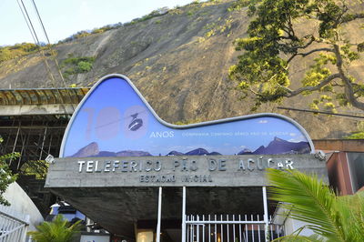 Low angle view of store against rock formation