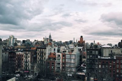 Cityscape against cloudy sky