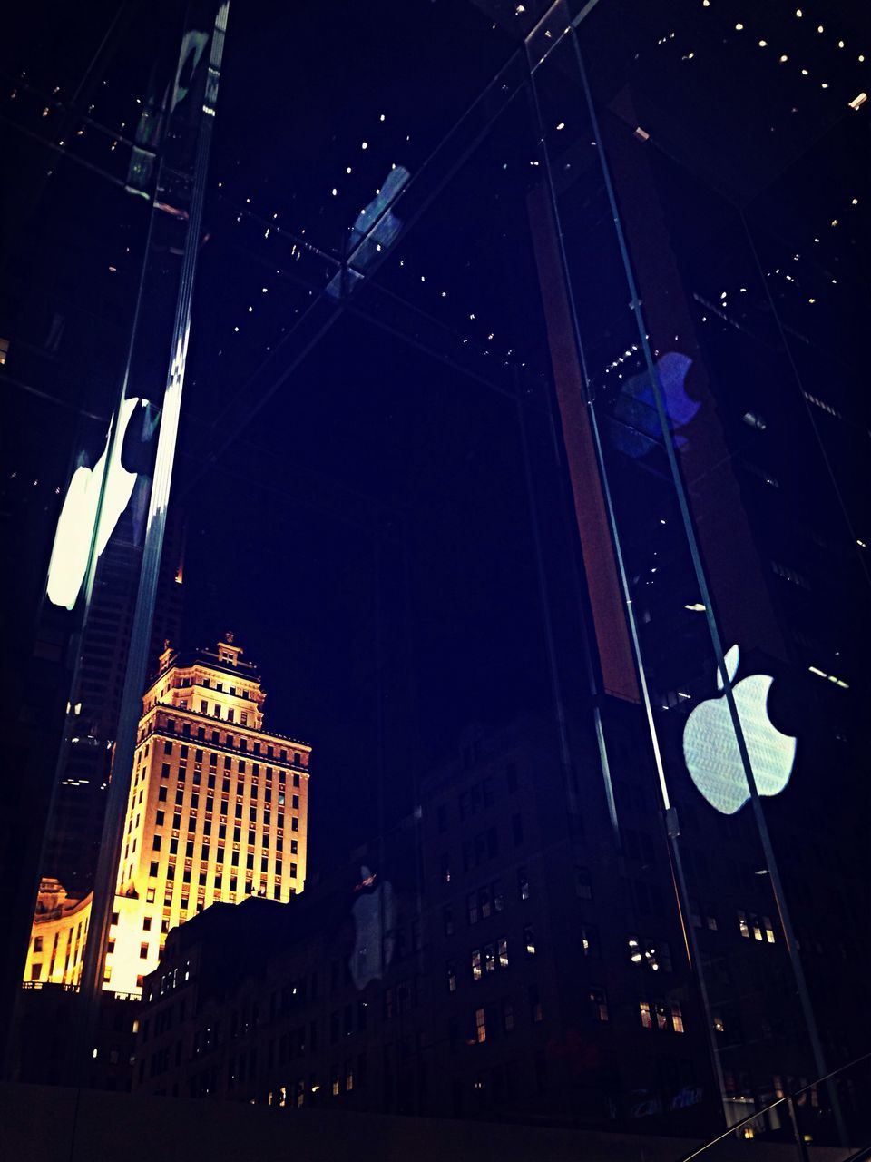 night, illuminated, low angle view, building exterior, architecture, built structure, city, sky, lighting equipment, dark, electricity, light - natural phenomenon, outdoors, building, tall - high, no people, glowing, light, skyscraper, modern