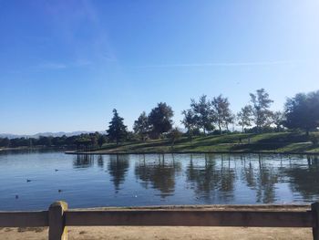 Scenic view of lake against clear blue sky