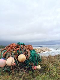 Fishing net on beach against sky