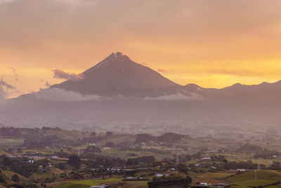 Scenic view of snowcapped mountains against sky during sunset