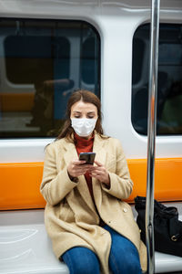 Young woman sitting in train