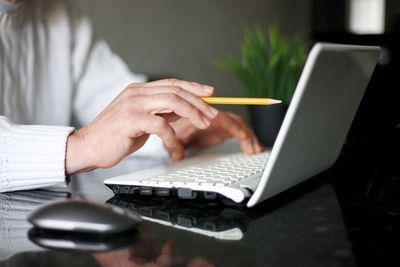 Midsection of woman using mobile phone