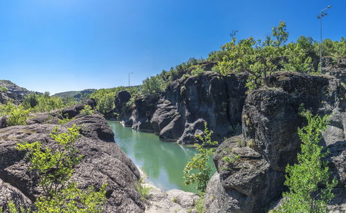 Scenic view of waterfall against sky