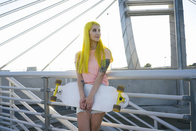 Woman standing by railing