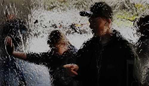 Reflection of people on wet glass