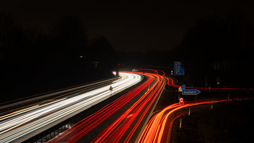 Long exposure, white front and red rear lights as car light strips at night