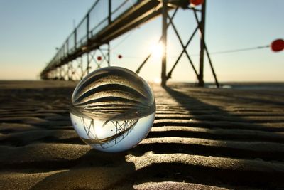 Low angle view of crystal ball against sky during sunset