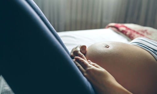 Pregnant woman lying on bed