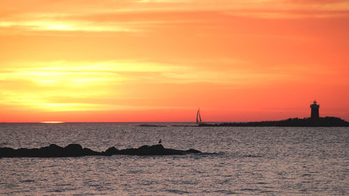 Scenic view of sea against orange sky