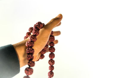 Close-up of woman hand against white background