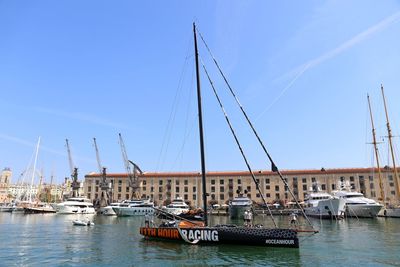 Sailboats moored in harbor