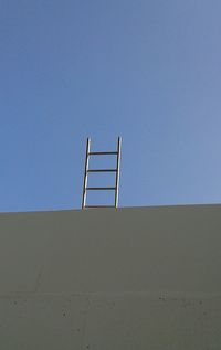 Low angle view of built structure against clear blue sky