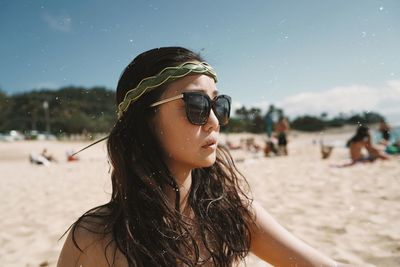 Portrait of young woman wearing sunglasses on beach