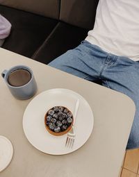 Midsection of woman having breakfast