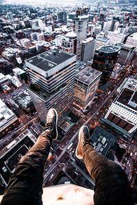 Low section of man with cityscape in background