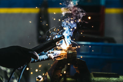 Close-up of man repairing machinery