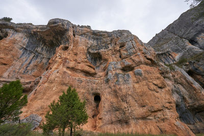 Low angle view of rock formations against sky