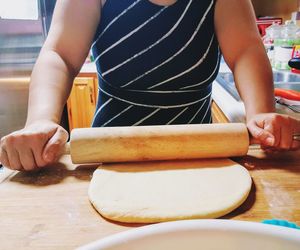 Midsection of woman preparing food at home