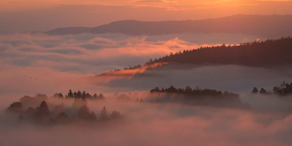 Scenic view of silhouette mountains against sky during sunset