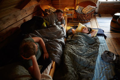 High angle view of people relaxing on bed