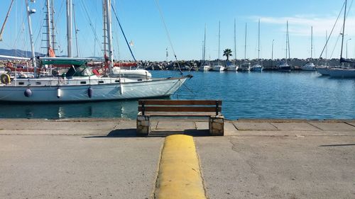Sailboats moored at harbor