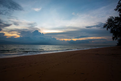 Scenic view of beach against sky during sunset