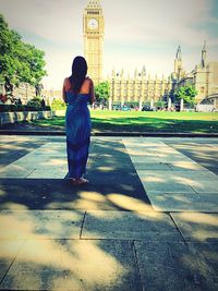 Woman standing on footpath