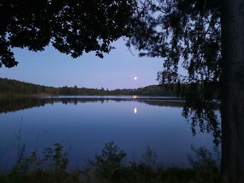 Scenic view of lake against sky at night