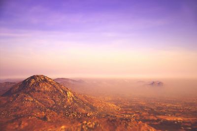 Scenic view of mountains against sky at sunset