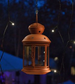 Close-up of lantern hanging at night