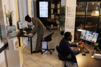 Man using phone while sitting on table