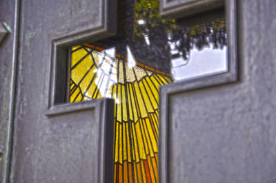 Close-up of yellow window of building