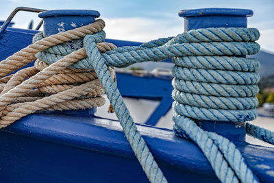 Close-up of ropes tied to bollard