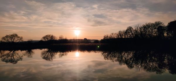 Scenic view of lake against sky during sunset