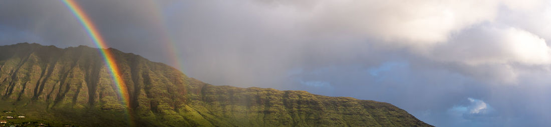 Rainbow over mountain against sky