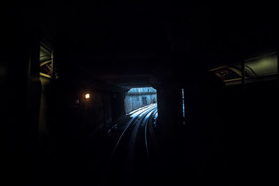 Illuminated tunnel at night