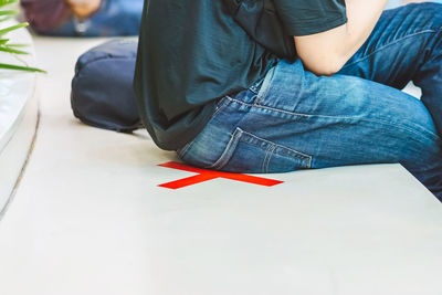 Low section of man sitting on floor