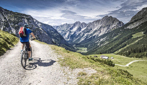 Rear view of cyclist on country road